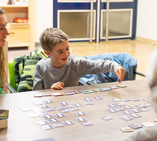 Young boy playing game at table